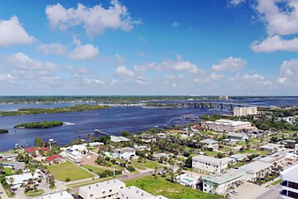 Aerial view of Port Orange, Florida with residential neighborhoods, greenery, and waterways. Aerial view of Port Orange, Florida with residential neighborhoods, greenery, and waterways.