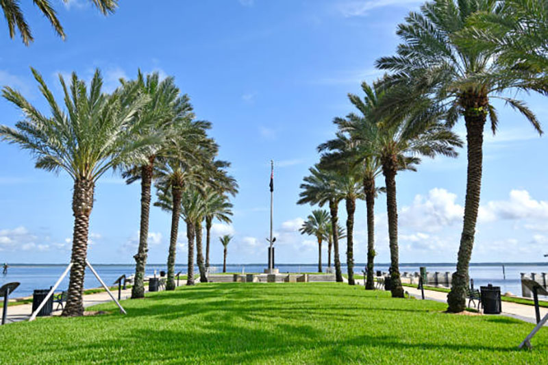 Waterfront park and palm trees along the Sanford Riverwalk near downtown Sanford, Florida